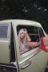 a woman sitting in the back seat of a car